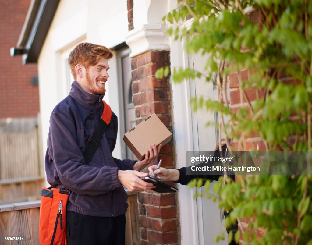 Postman delivering package to resident