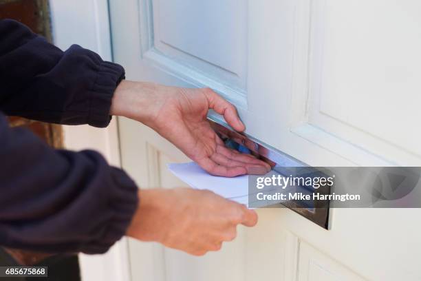 close up of postman delivering letters - mailman stock pictures, royalty-free photos & images