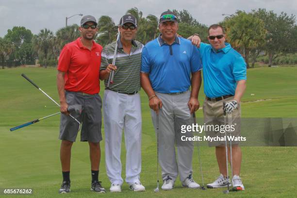 Former Major League Baseball Players Andres Galarraga and Dennis Martinez with Gil Martinez and Anthony Portillia attend the Clinics Can Help 4th...