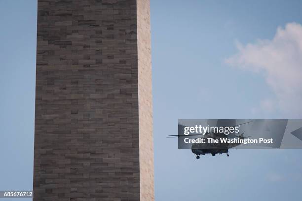 Marine One, with President Donald Trump and first lady Melania Trump aboard, flys by the Washington Monument after taking off from the South Lawn for...