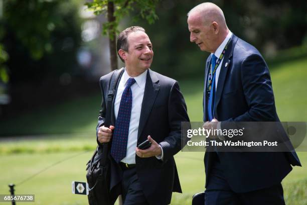 White House Chief of Staff Reince Priebus, left, and Director of Oval Office operations Keith Schiller, right, walk across the South Lawn to board...