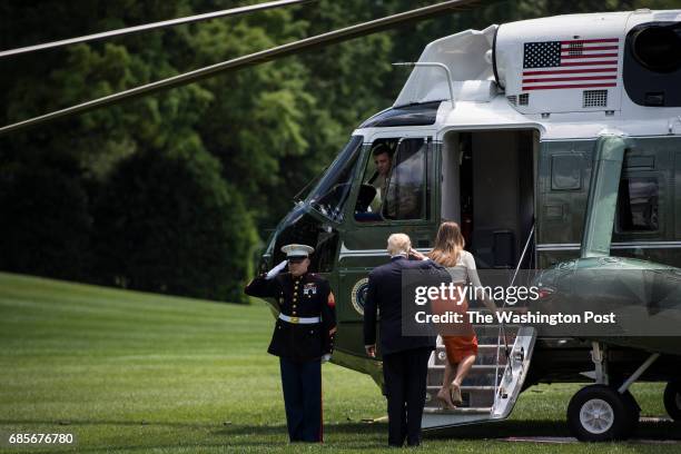 President Donald Trump and first lady Melania Trump board Marine One to fly to Andrews Air Force Base, Md. From the South Lawn at the White House in...