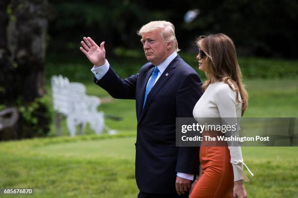 President Donald Trump and first lady Melania Trump walk across the South Lawn to board Marine One and fly to Andrews Air Force Base, Md., at the...