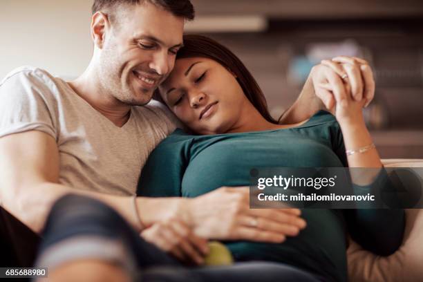 touching moment between future parents - pregnant couple stock pictures, royalty-free photos & images