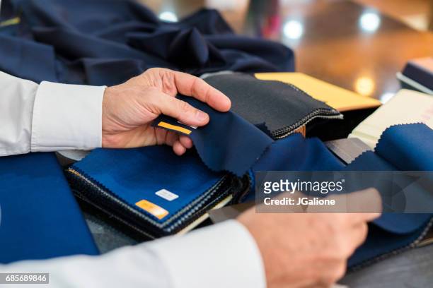 man checking fabric swatches - bespoke stock pictures, royalty-free photos & images