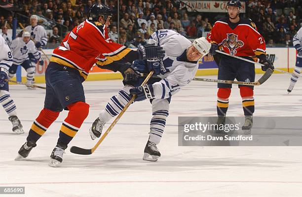 Right wing Darcy Tucker of the Toronto Maple Leafs releases a shot against defenseman Brad Ference of the Florida Panthers during the NHL game at Air...