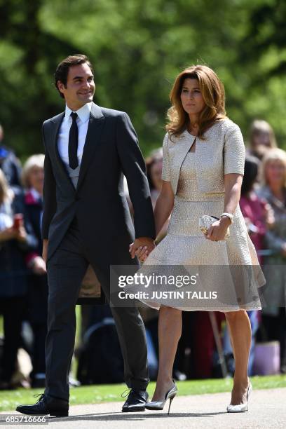 Swiss tennis player Roger Federer and his wife Mirka attend the wedding of Pippa Middleton and James Matthews at St Mark's Church in Englefield, west...