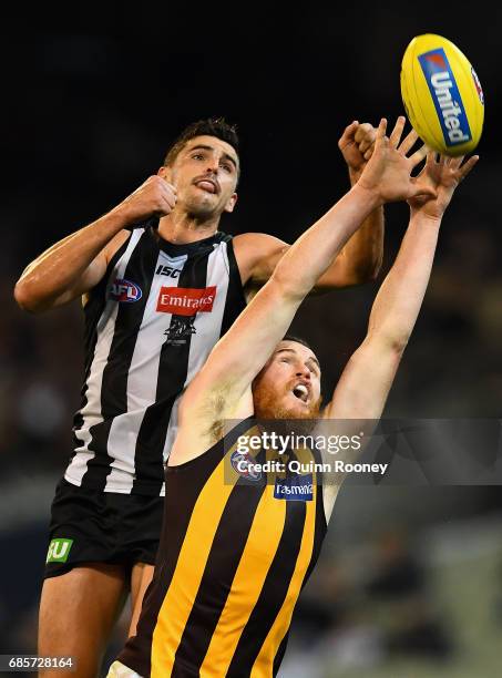 Scott Pendlebury of the Magpies spoils a mark by Jarryd Roughead of the Hawks during the round nine AFL match between the Collingwood Magpies and the...