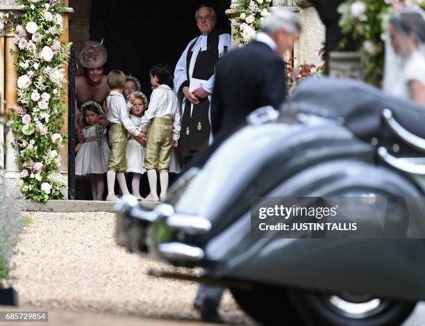 Britain's Catherine, Duchess of Cambridge stands with her daughter Britain's princess Charlotte, and the other bridesmaids and pageboys, as they...