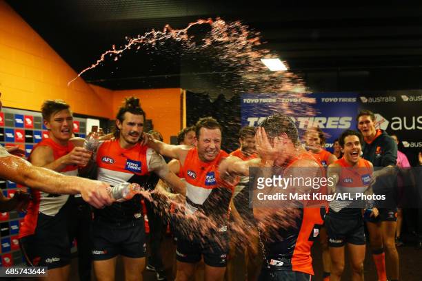 Harry Perryman of the Giants celebrates victory with team mates and sing the team song after the round nine AFL match between the Greater Western...