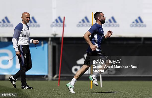 Daniel Carvajal of Real Madrid exercises with physical trainer Antonio Pintus during a training session at Valdebebas training ground on May 20, 2017...