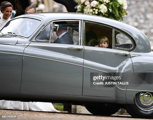 Britain's Prince George waves as he leaves in a car after attending the wedding of his aunt, Pippa Middleton , to James Matthews at St Mark's Church...