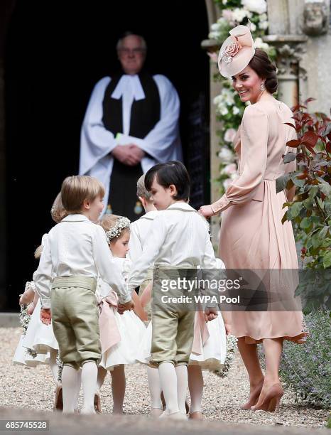 Catherine, Duchess of Cambridge, right, arrives with the pageboys and flower girls for the wedding of Pippa Middleton and James Matthews at St Mark's...