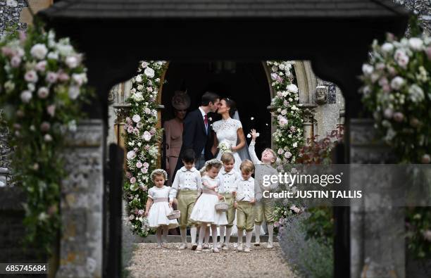 Pippa Middleton kisses her new husband James Matthews, following their wedding ceremony at St Mark's Church in Englefield, west of London, on May 20...