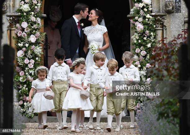 Pippa Middleton kisses her new husband James Matthews, following their wedding ceremony at St Mark's Church in Englefield, west of London, on May 20...