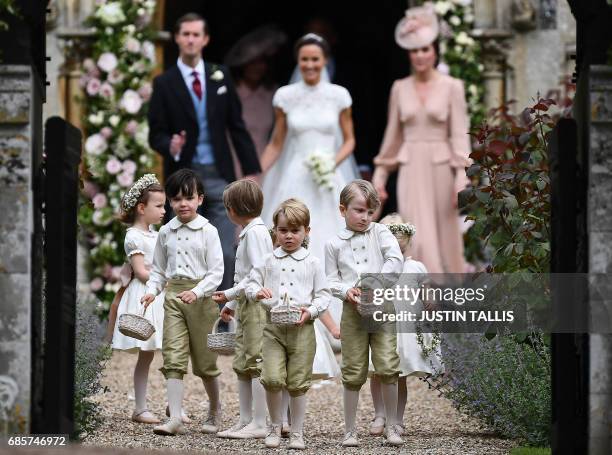 Britain's prince George , a pageboy, reacts following the wedding of his aunt Pippa Middleton to her new husband James Matthews , at St Mark's Church...