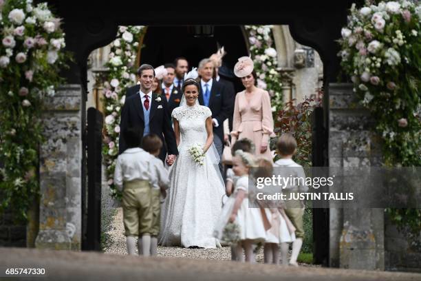 Britain's Catherine, Duchess of Cambridge, watches as her sister Pippa Middleton walks with her new husband James Matthews , following their wedding...