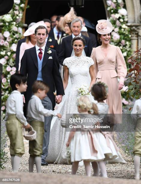 Pippa Matthews and James Matthews exit the church after their wedding ceremony followed by Catherine, Duchess of Cambridge at St Mark's Church on May...