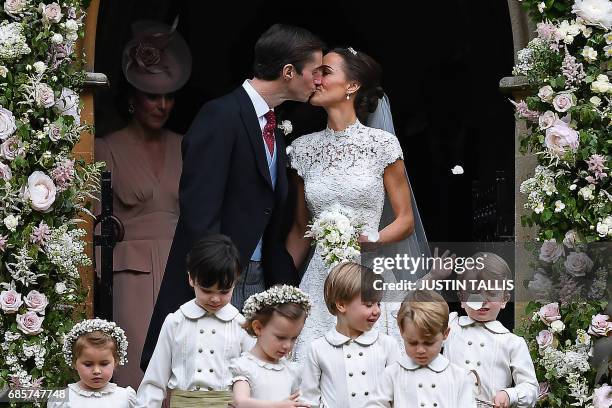 Pippa Middleton kisses her new husband James Matthews, following their wedding ceremony at St Mark's Church in Englefield, west of London, on May 20...