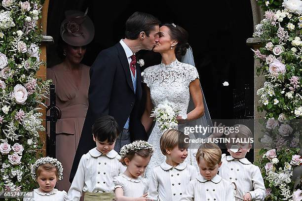 Pippa Middleton kisses her new husband James Matthews, following their wedding ceremony at St Mark's Church in Englefield, west of London, on May 20...