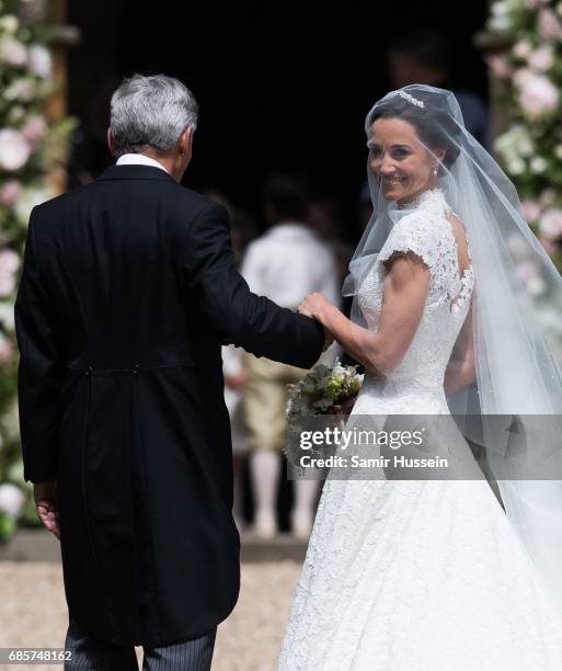 Pippa Middleton and Michael Middleton arrive for the wedding Of Pippa Middleton and James Matthews at St Mark's Church on May 20, 2017 in Englefield...