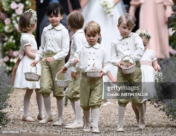 Britain's prince George , a pageboy, reacts following the wedding of his aunt Pippa Middleton to her new husband James Matthews, at St Mark's Church...