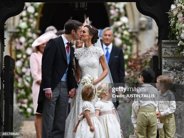 Pippa Middleton kisses her new husband James Matthews, following their wedding ceremony at St Mark's Church in Englefield, west of London, on May 20...