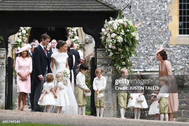 Britain's Catherine, Duchess of Cambridge stands with her children Britain's prince George and Britain's princess Charlotte, following the wedding of...