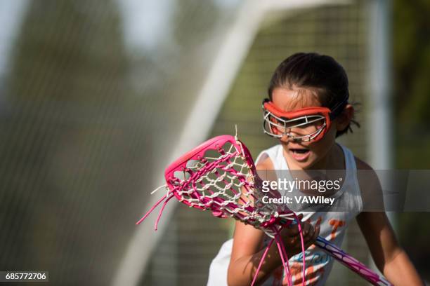 young girl playing sports outside - lacrosse imagens e fotografias de stock