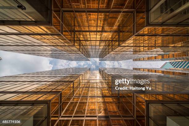 hong kong. gold colored glass curtain wall of malls at china hong kong city - tsim sha tsui stock-fotos und bilder