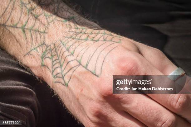 spider web tattoo on man's hand and arm - tumring bildbanksfoton och bilder