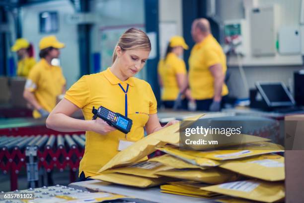 trabajadora postal - oficina de correos fotografías e imágenes de stock