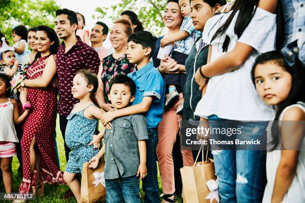 Multigenerational family having birthday party gathered for family portrait