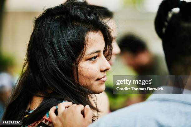 Young woman hanging out with friends and family during backyard party