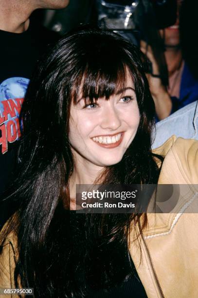 Beverly Hills 90210 actress Shannen Doherty poses with fans as she attends the Planet Hollywood Grand Opening Celebration on October 23, 1992 at...