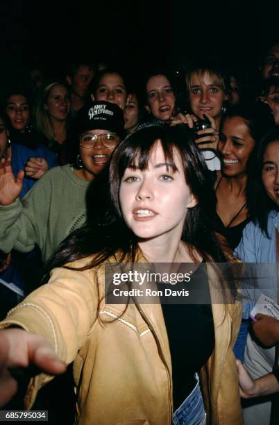 Beverly Hills 90210 actress Shannen Doherty poses with fans as she attends the Planet Hollywood Grand Opening Celebration on October 23, 1992 at...