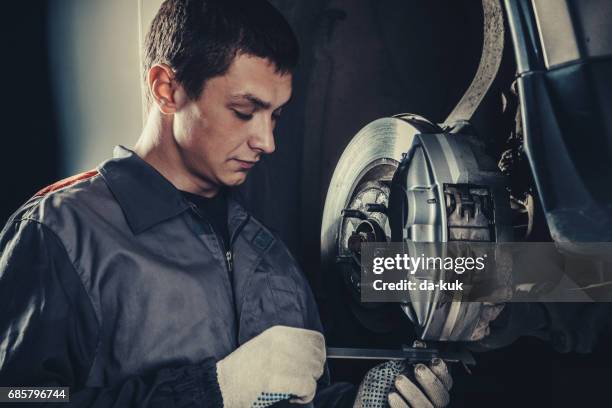 professional car mechanic repairing brakes - diagnostic aid stock pictures, royalty-free photos & images