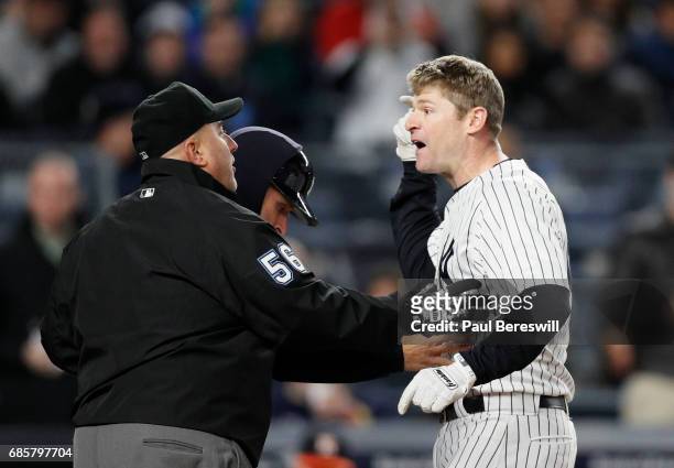 May 12: Chase Headley of the New York Yankees argues with umpire crew chief Eric Cooper after getting hit in the hand by a pitch on a bunt attempt...