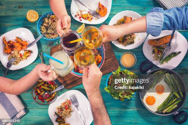 young family having lunch at home - white wine overhead stock pictures, royalty-free photos & images