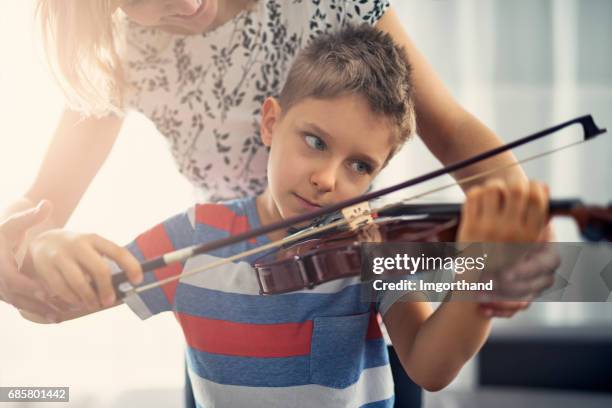 little boy having violin lesson - violin lesson stock pictures, royalty-free photos & images