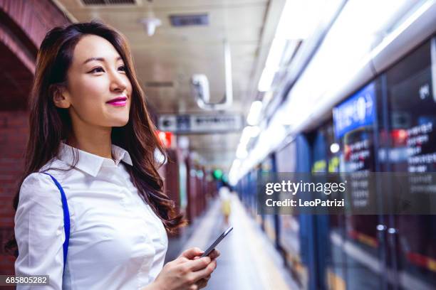 young business woman waiting for the train in seoul suwbay - south korea woman stock pictures, royalty-free photos & images