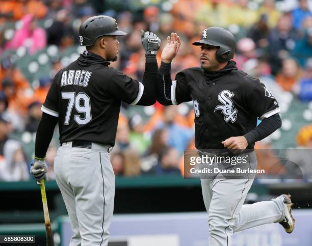 Geovany Soto of the Chicago White Sox high-fives Jose Abreu of the Chicago White Sox after scoring against the Detroit Tigers at Comerica Park on...