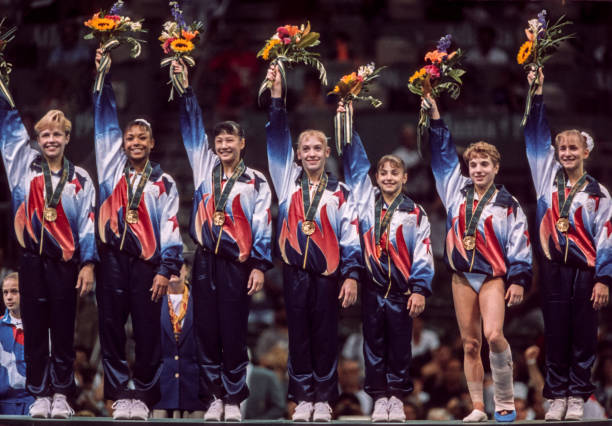 The United States Women's Gymnastics Team of Amanda Borden, Dominique Dawes, Amy Chow, Jaycie Phelps, Dominique Moceanu, Kerri Strug, and Shannon...