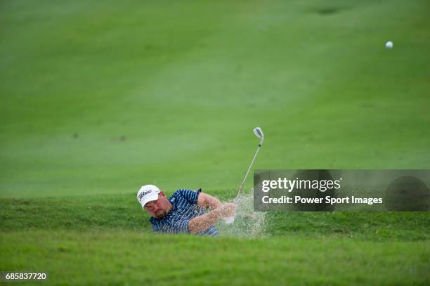 Brendon de Jonge chips out of a bunker on the tenth fairway during the final round of play at the CIMB Asia Pacific Classic 2011 at the MINES resort...