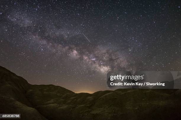 lyrid meteor and milky way over a mars-like landscape - april lyrids stock pictures, royalty-free photos & images
