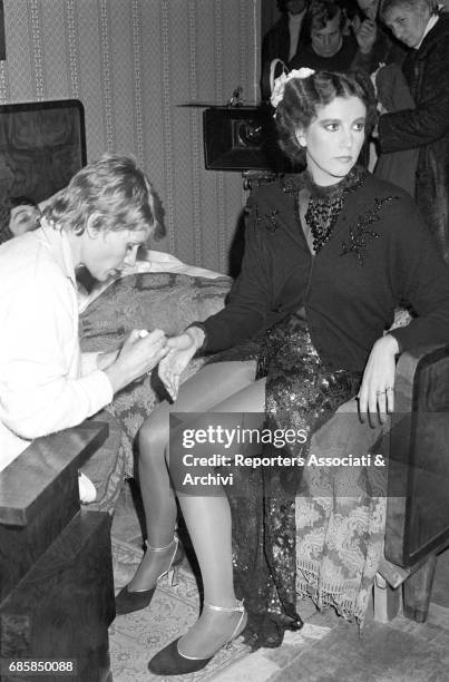 Italian actress Stefania Sandrelli having her nails polished on the set of Disobedience. 1981