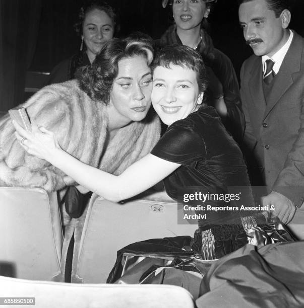 Italian actress Alida Valli kissing Italian actress Valentina Cortese at Teatro Quirino for the premiere of Otello. Rome, 2 November 1956