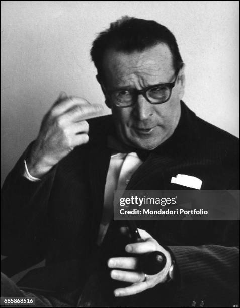Belgian writer Georges Simenon with a pipe in his hand during a conversation. 1960s
