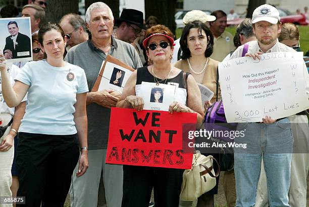 Family members of 9/11 victims hold posters and pictures of their loved ones during a rally on Capitol Hill June 11, 2002 in Washington, DC. The...