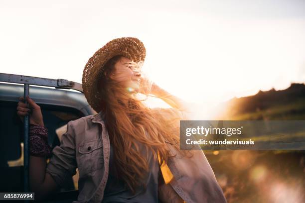 country girl enjoying nature in the back of a truck - retro cowgirl stock pictures, royalty-free photos & images